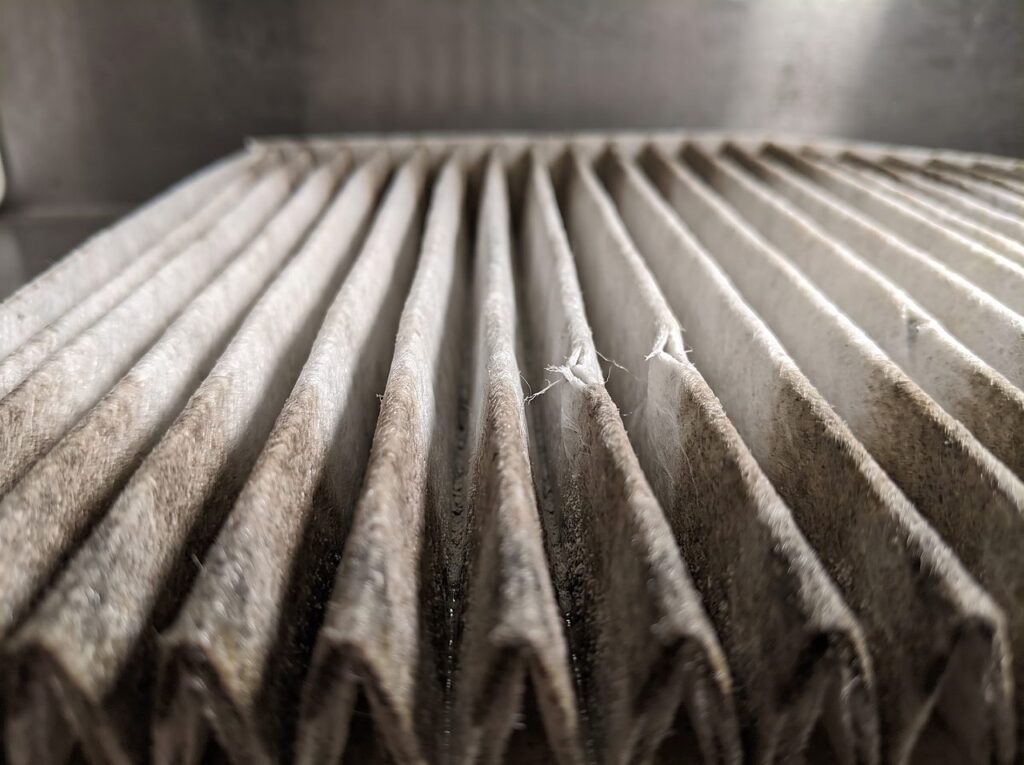 close-up of a spa filter's pleats flattened and discolored from fiber fatigue
