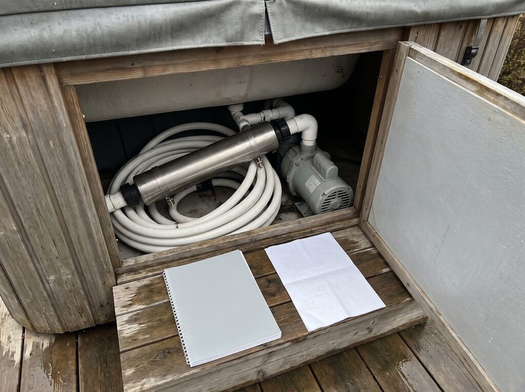looking into a hot tub equipment bay where the salt cell wires into the plumbing